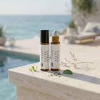 two bottles of essential oils on a ledge