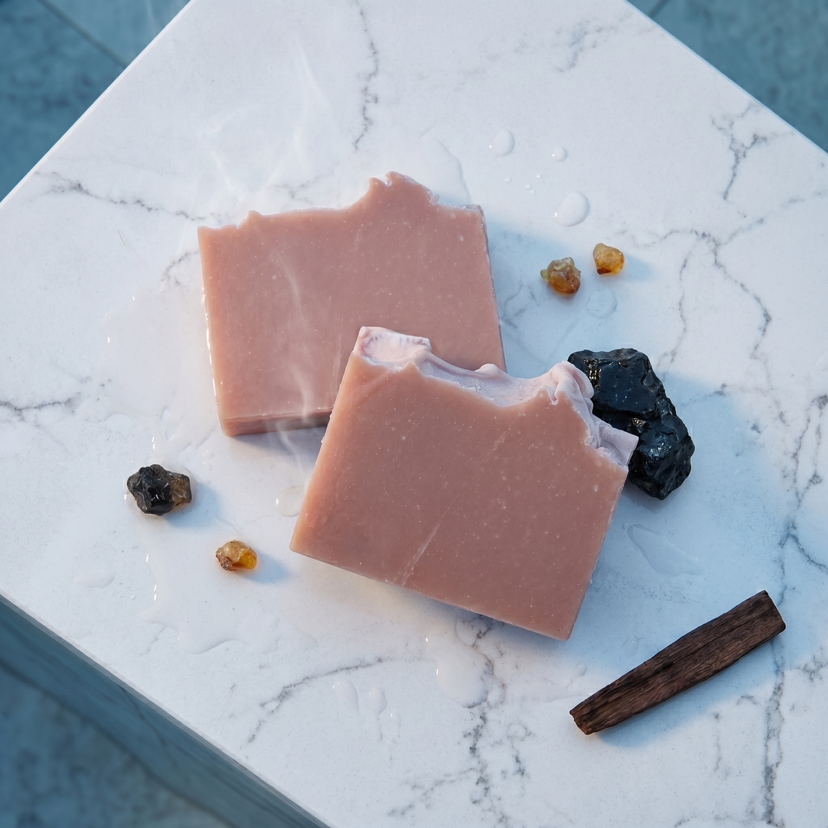 a pink bars of soap with a piece of candy and a cinnamon stick
