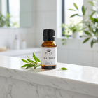 a small bottle of tea tree oil on a marble counter