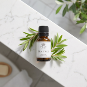 a small bottle of tea tree oil on a marble surface