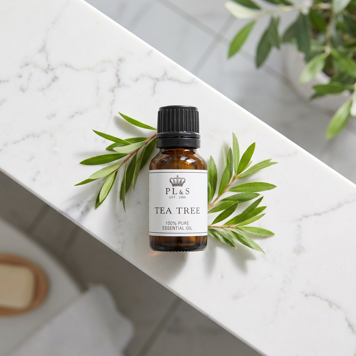 a small bottle of tea tree oil on a marble surface