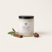 a jar of white candle next to acorns