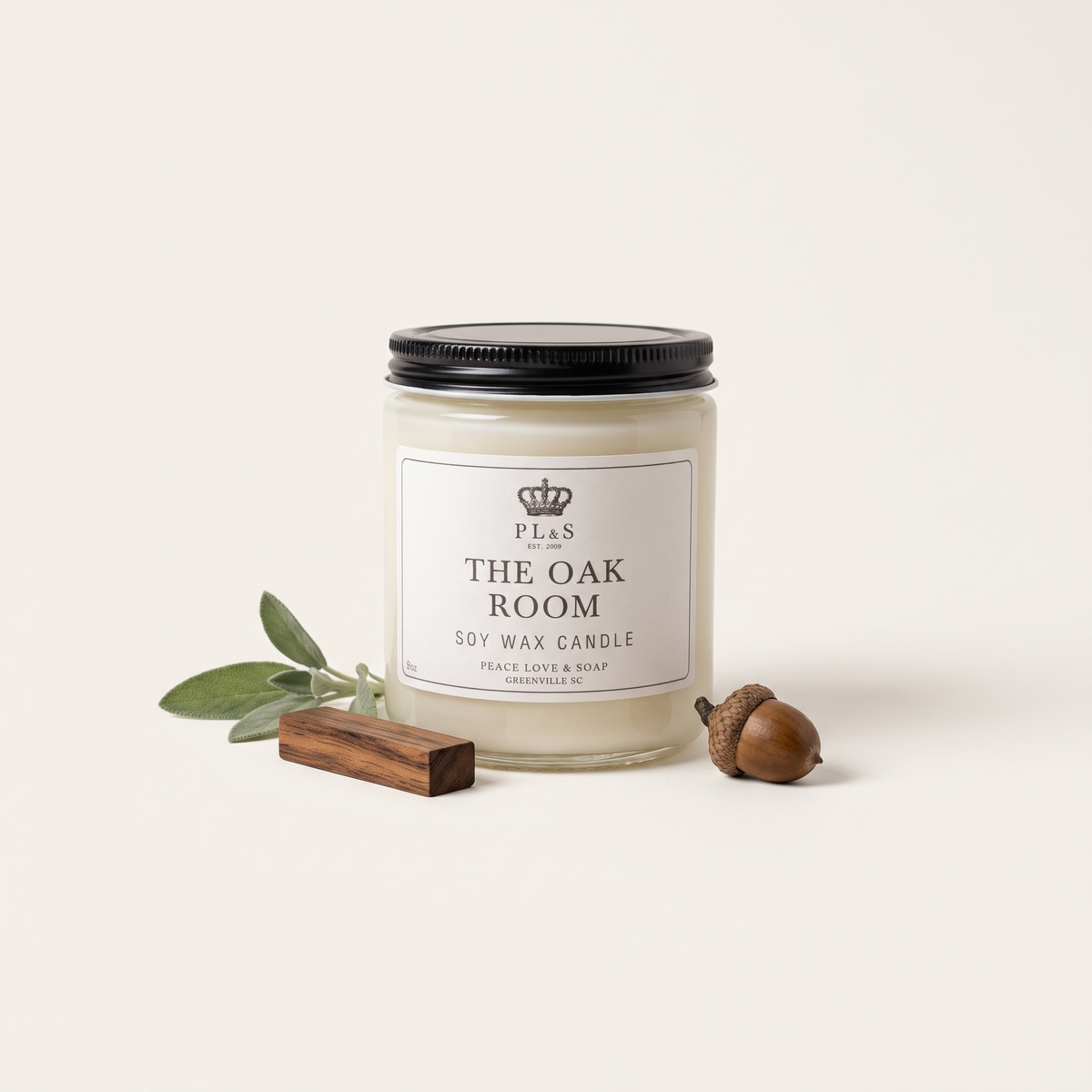 a jar of white candle next to acorns