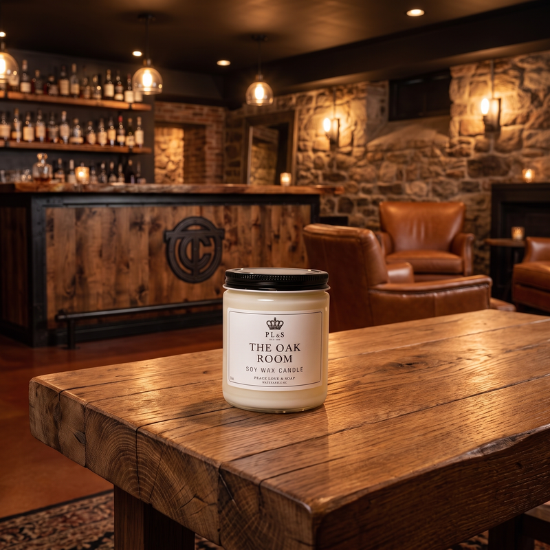 a white candle on a wooden table in a room with a stone fireplace and chairs