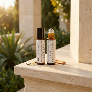 two bottles of essential oils on a stone ledge